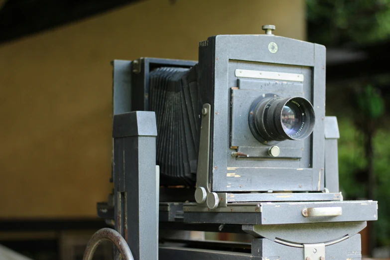 an old fashioned, two camera on top of a bench