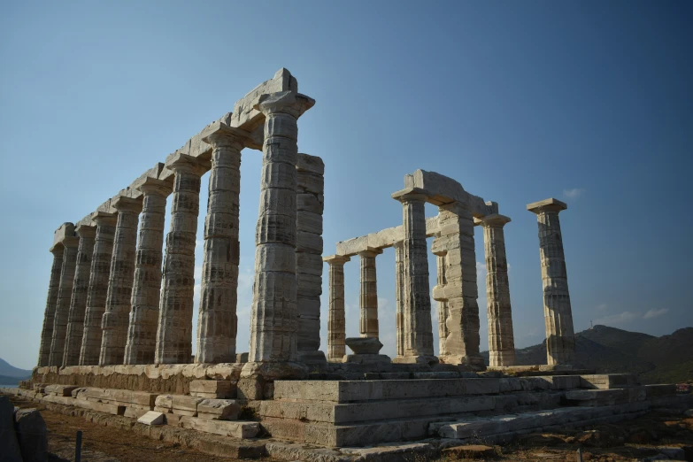 a group of columns standing against a blue sky