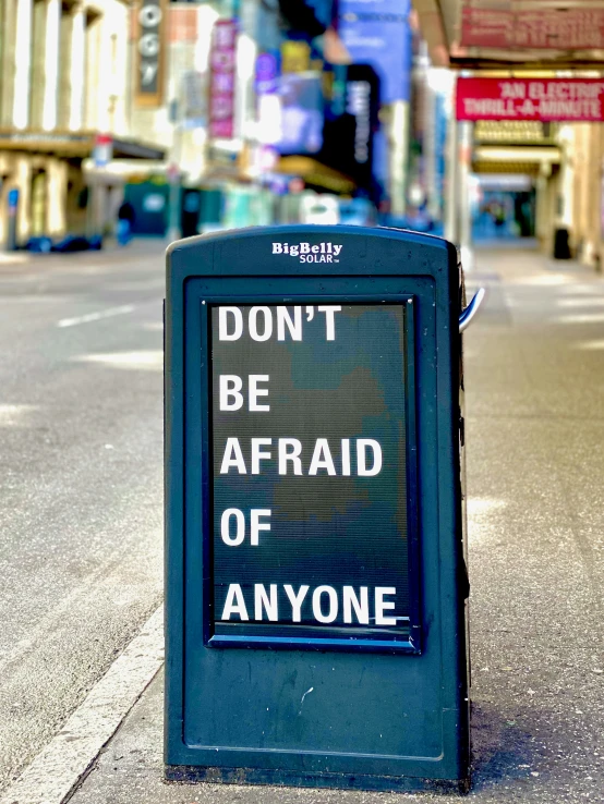 a blue box with don't be afraid of anyone written on it