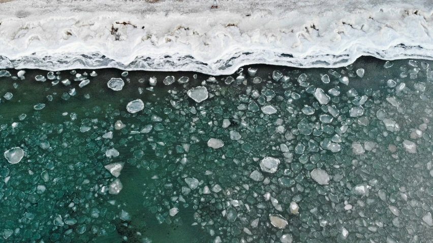 a water with waves and ice on it