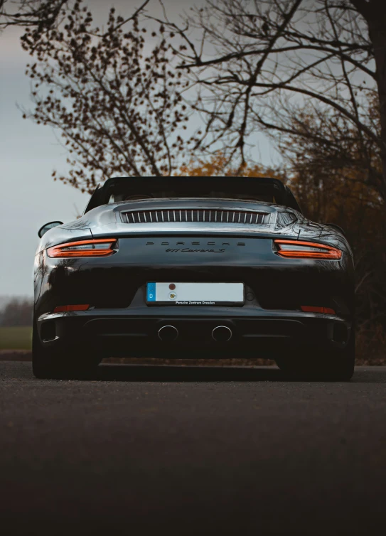 the back of a sleek looking sports car on a road