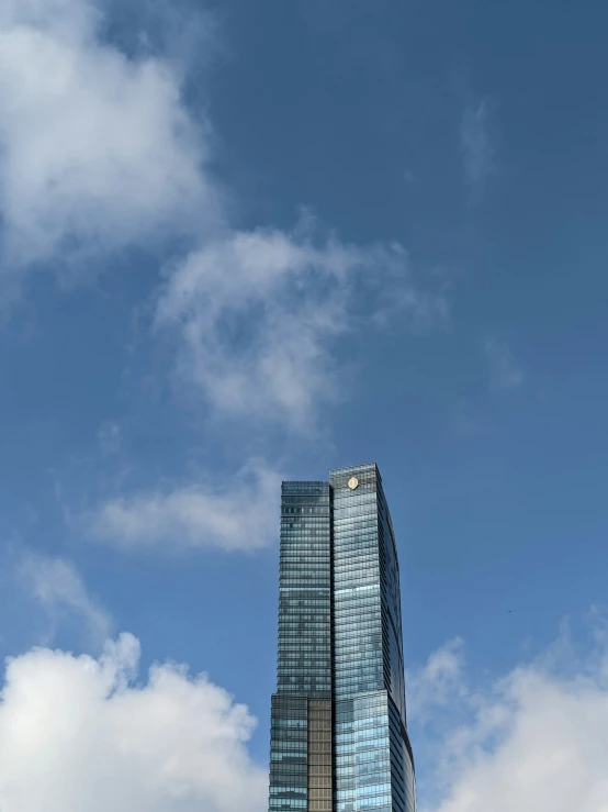 a glass and steel tower towering in the sky