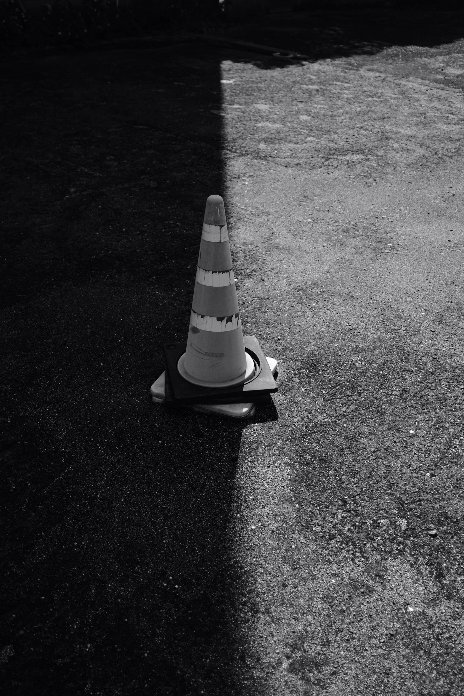 a black and white po of a cone laying on the ground