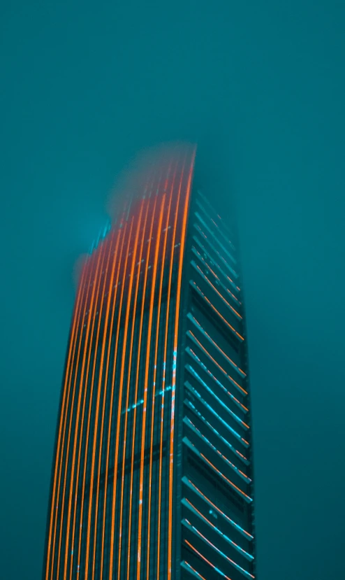 a very tall building with some bright colored lights