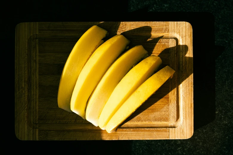 a wooden  board with a bunch of bananas on it