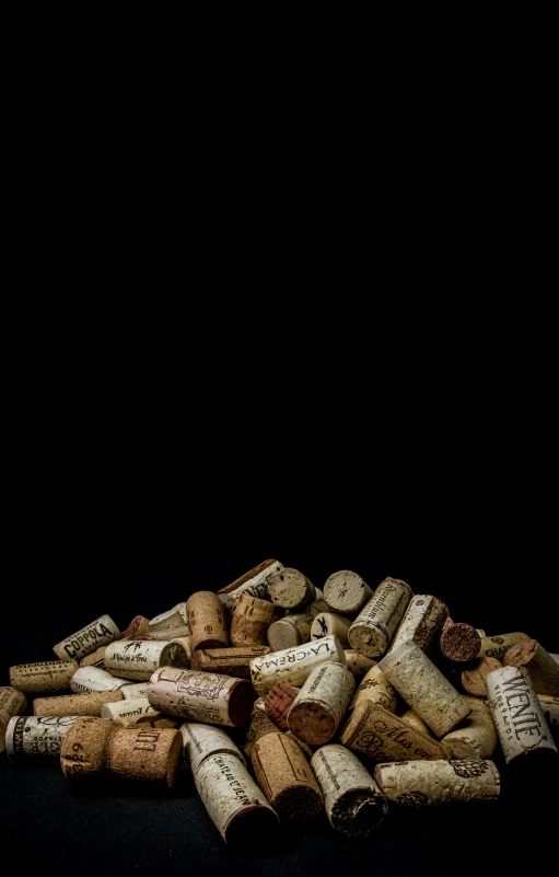 a pile of wine corks is shown on a dark background