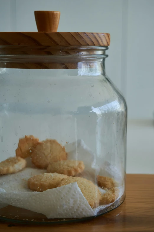 cookies, paper towels and other condiments are in a glass jar