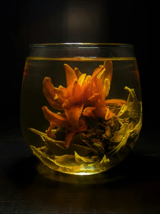 a clear bowl filled with water and flowers