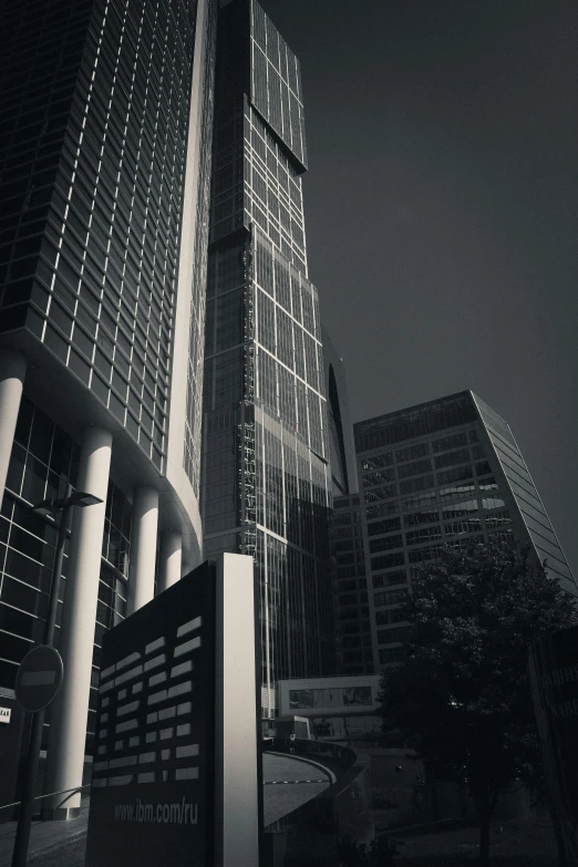 a big building is lit up with lights and it's glass panels