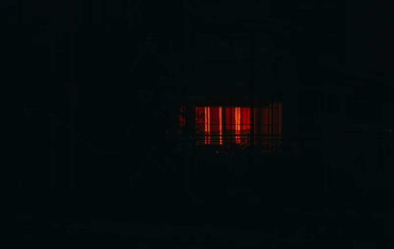 a red light is seen through a dark room