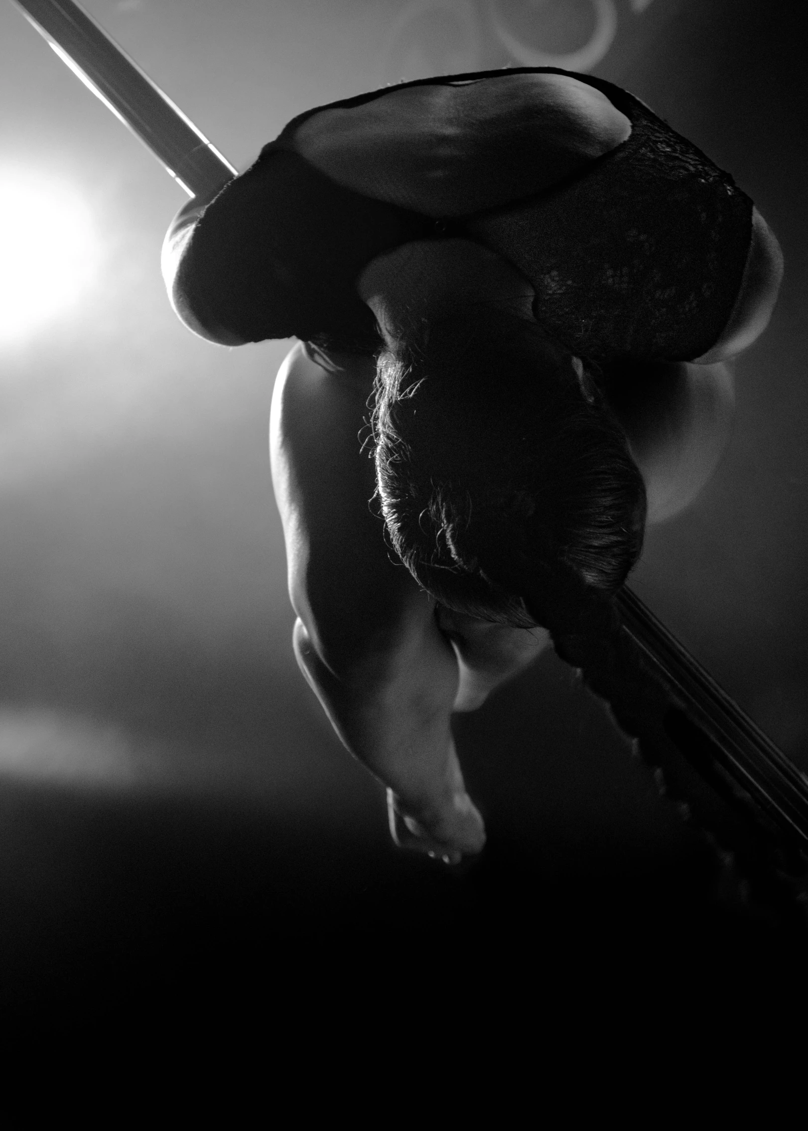 the hands and foot of a person with an instrument in a dark room