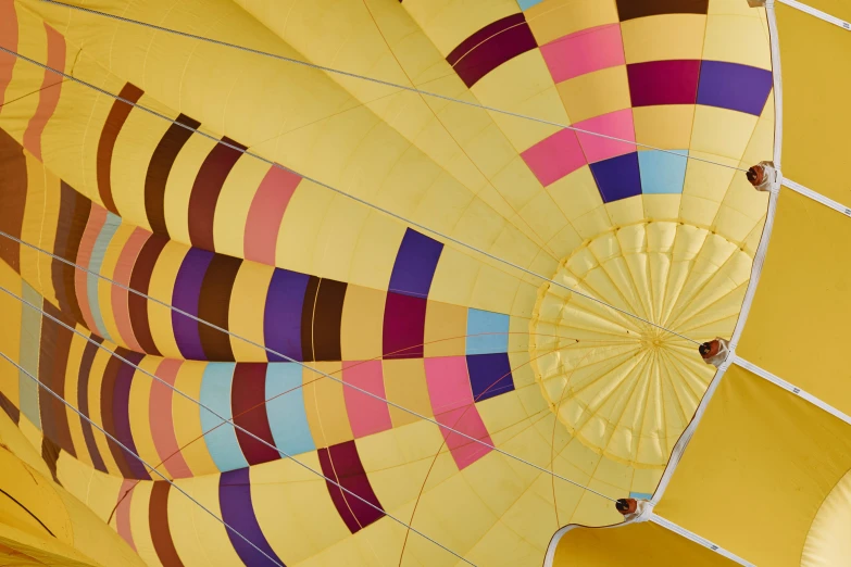 a colorful striped  air balloon hanging from the ceiling