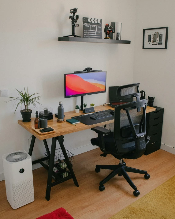 a desk with computer monitor and mouse in room