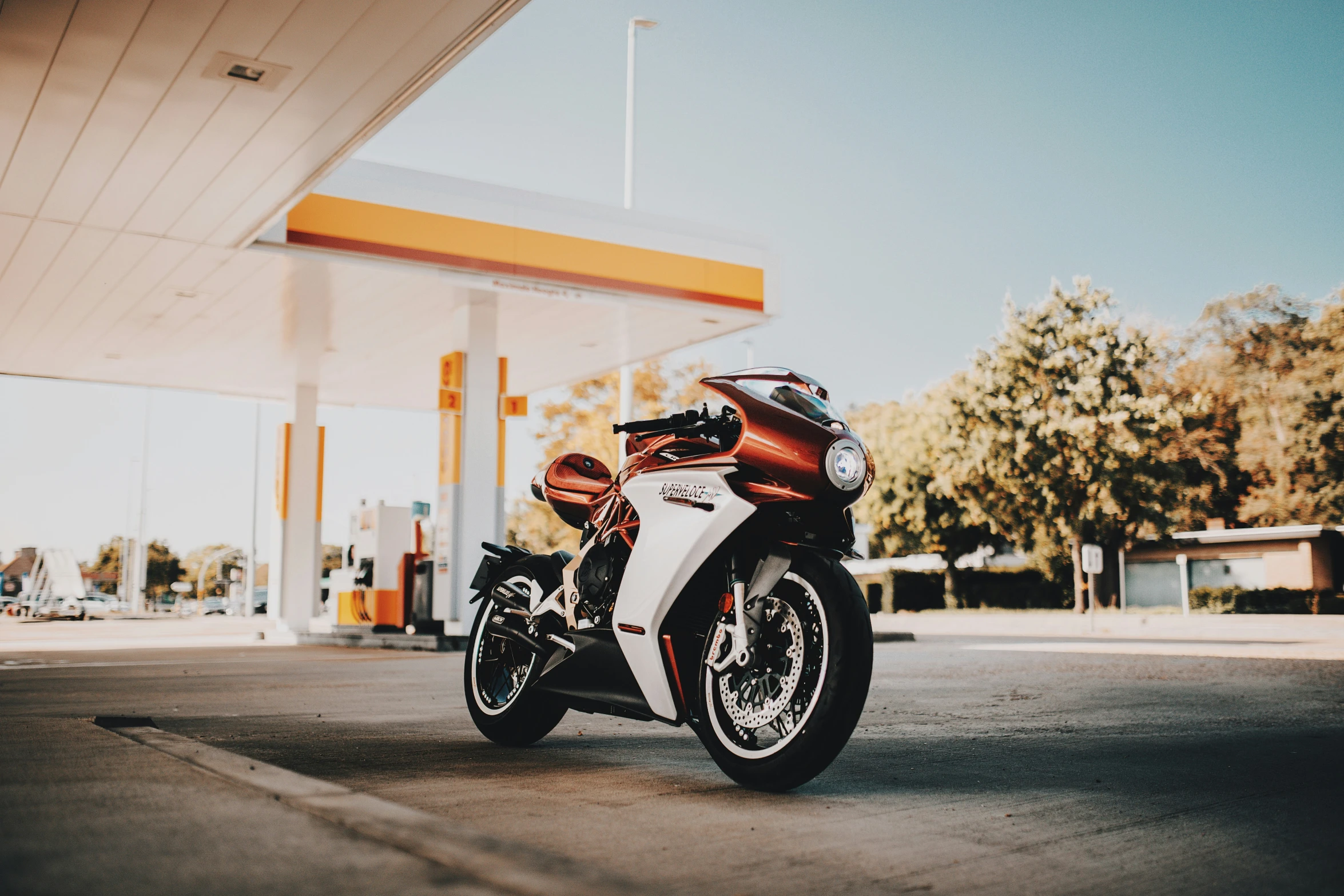 a motorcycle is parked in front of a gas station