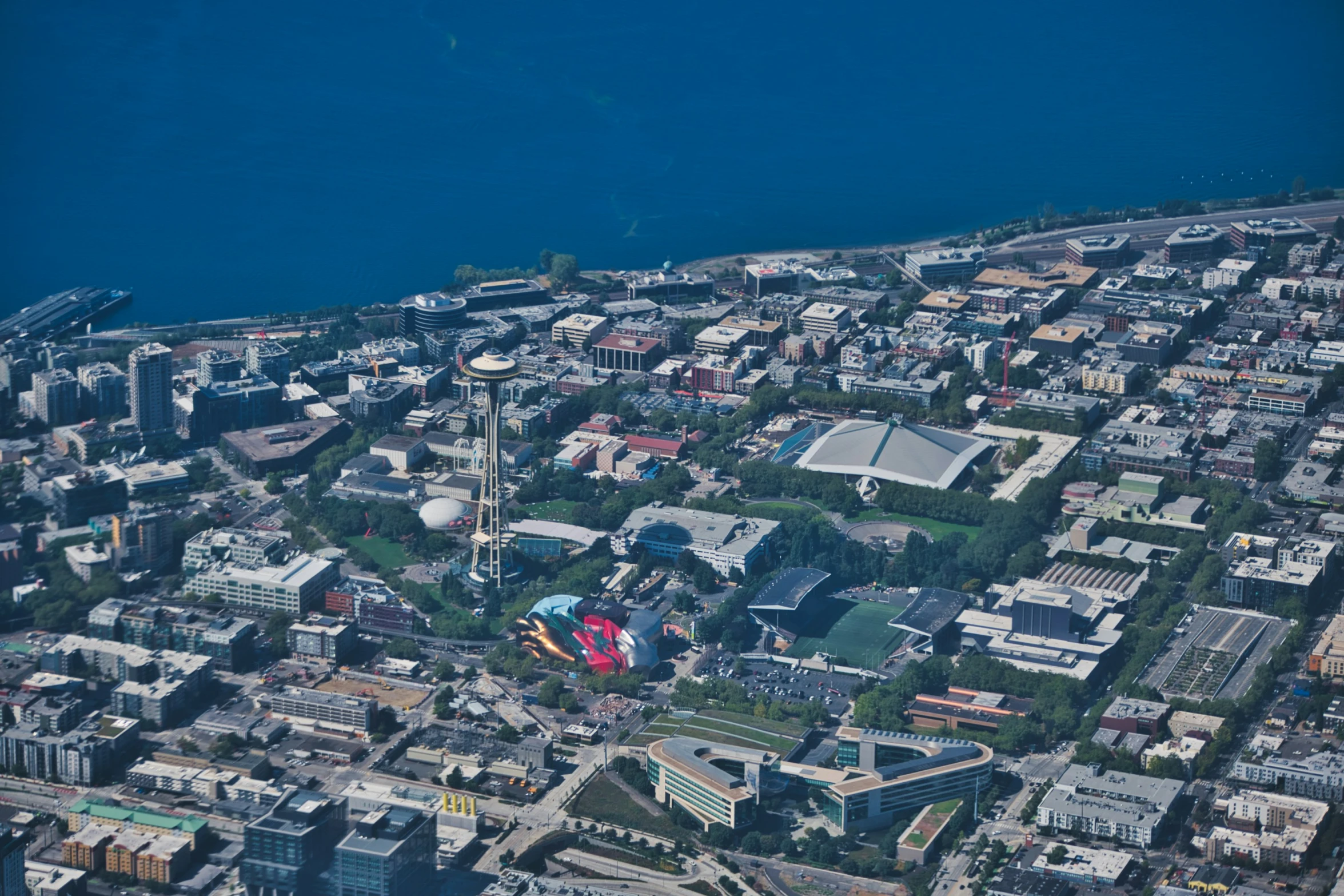 the view from a plane looking down on city buildings