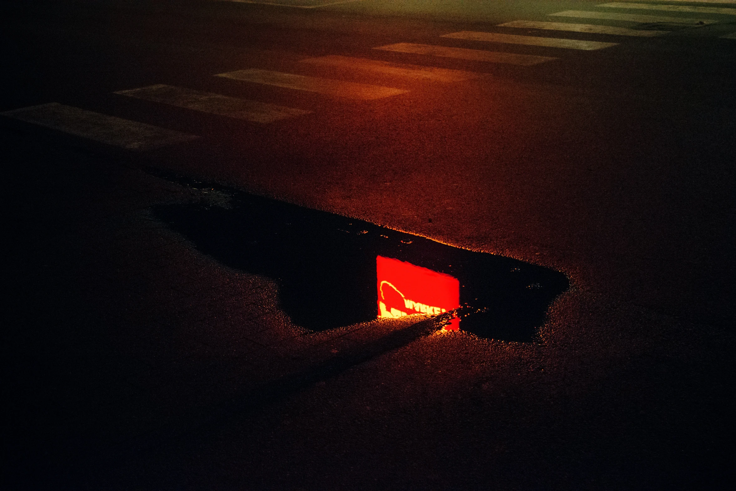 an orange rectangular light in the dark with a long handle