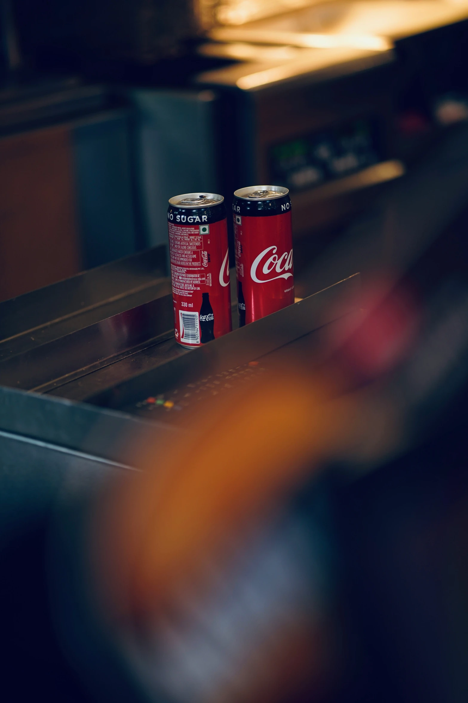 two empty red cans sitting on top of a counter