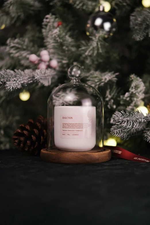 a candle and some pine cones on a table