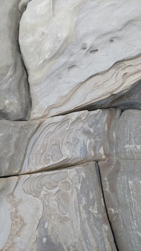 an artistic image of rocks and grey colored rock wall