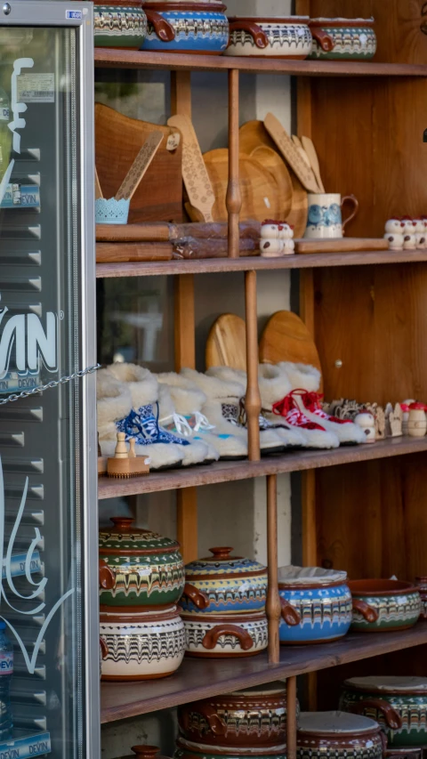 shelves filled with many ceramic pots and pans