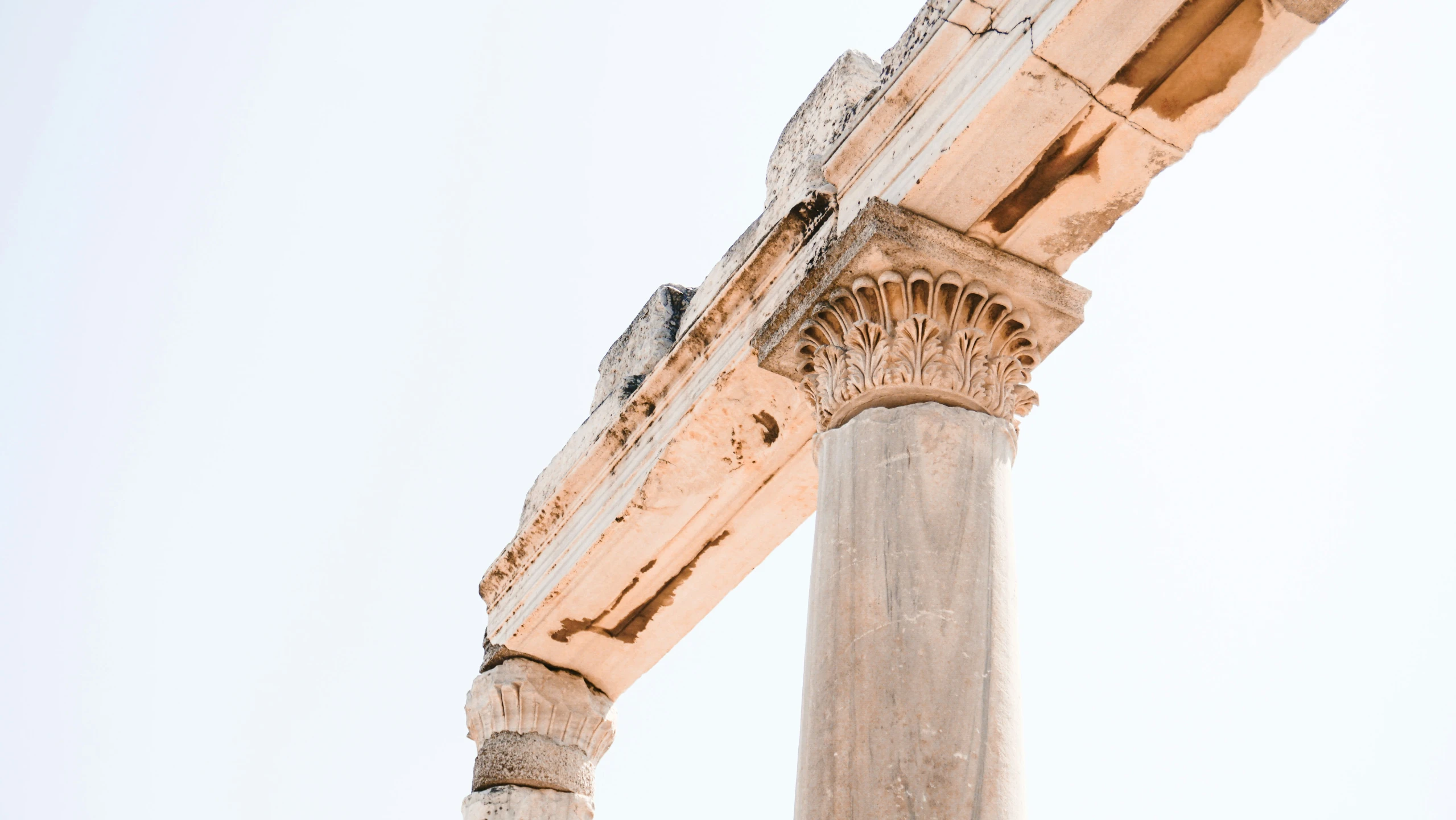 pillars against a sky background with a building in the background