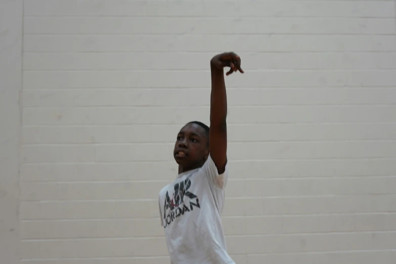 a young black man holding a basketball in front of him