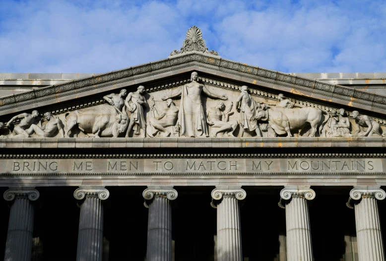 the building has many columns and statues on the side