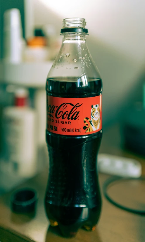 a bottle of coca cola on a wooden table
