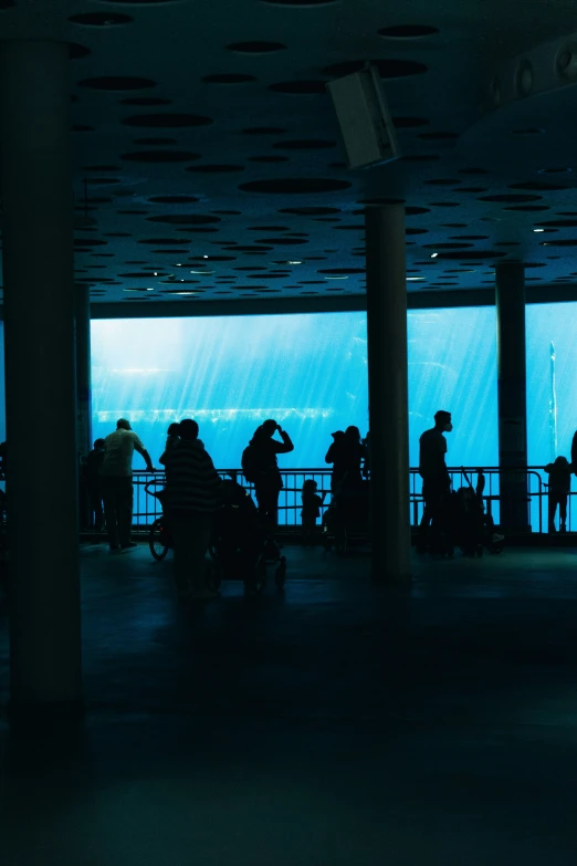 the terminal area in an airport with people milling about