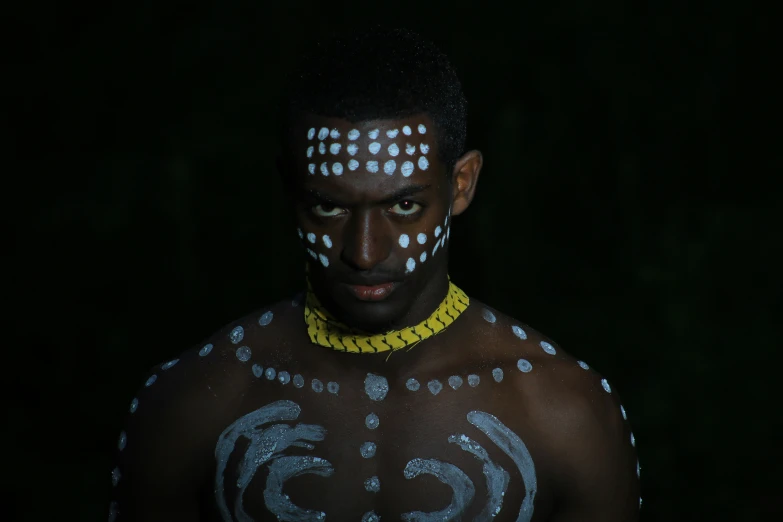 a man with his face painted in white and silver