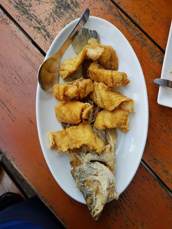 a plate with some food and a spoon on it