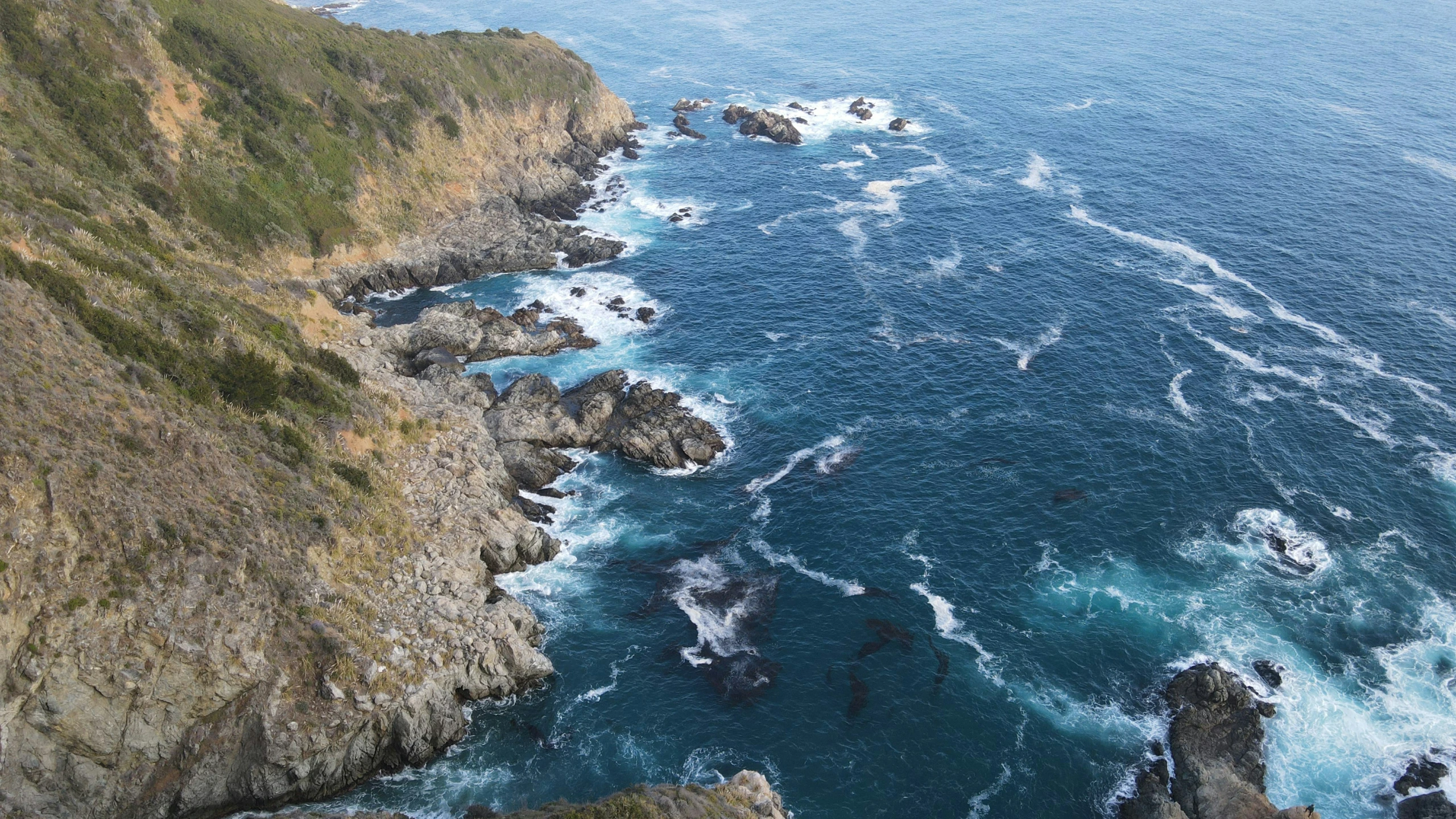 there is an island off in the water with many cliffs