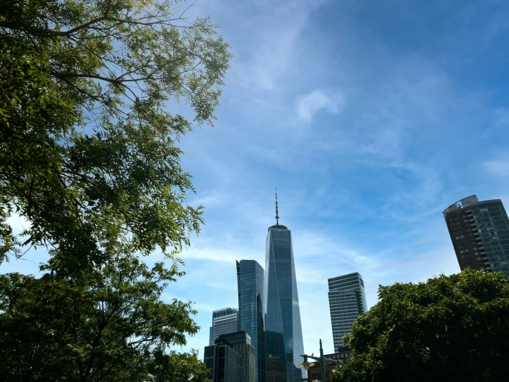 a tall skyscr towering over a city on a sunny day