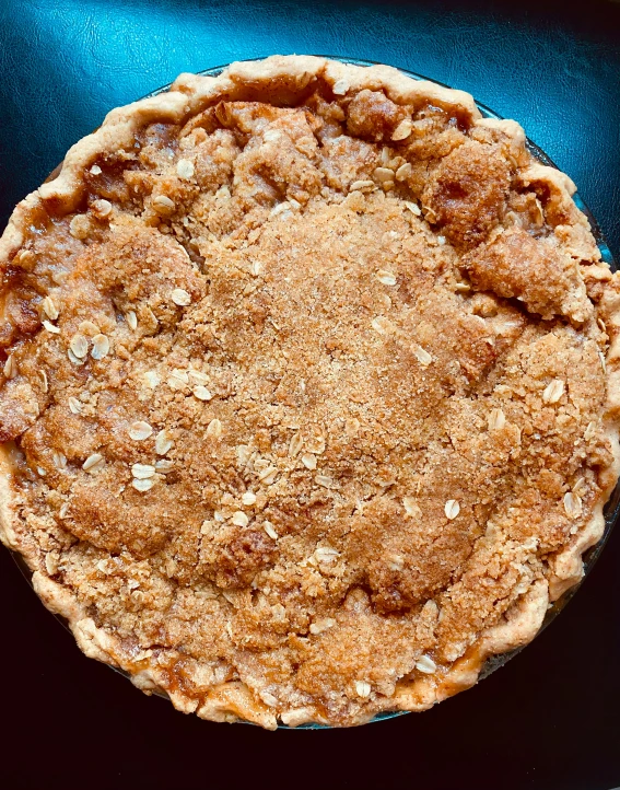 a pie that is on a pan with a spoon