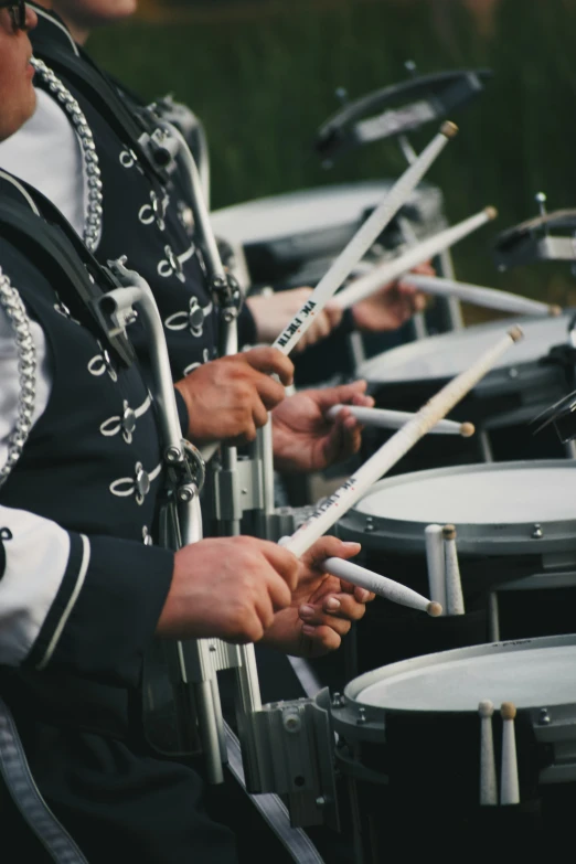 there are many men drumming together