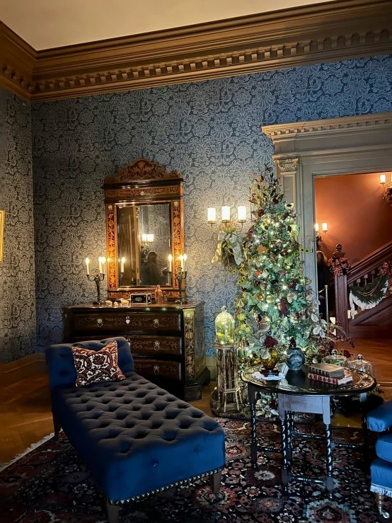 an old fashioned decorated living room with a christmas tree and decorative decorations