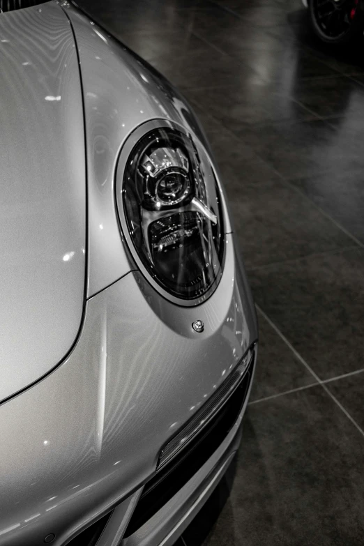 a grey sports car parked inside of a garage