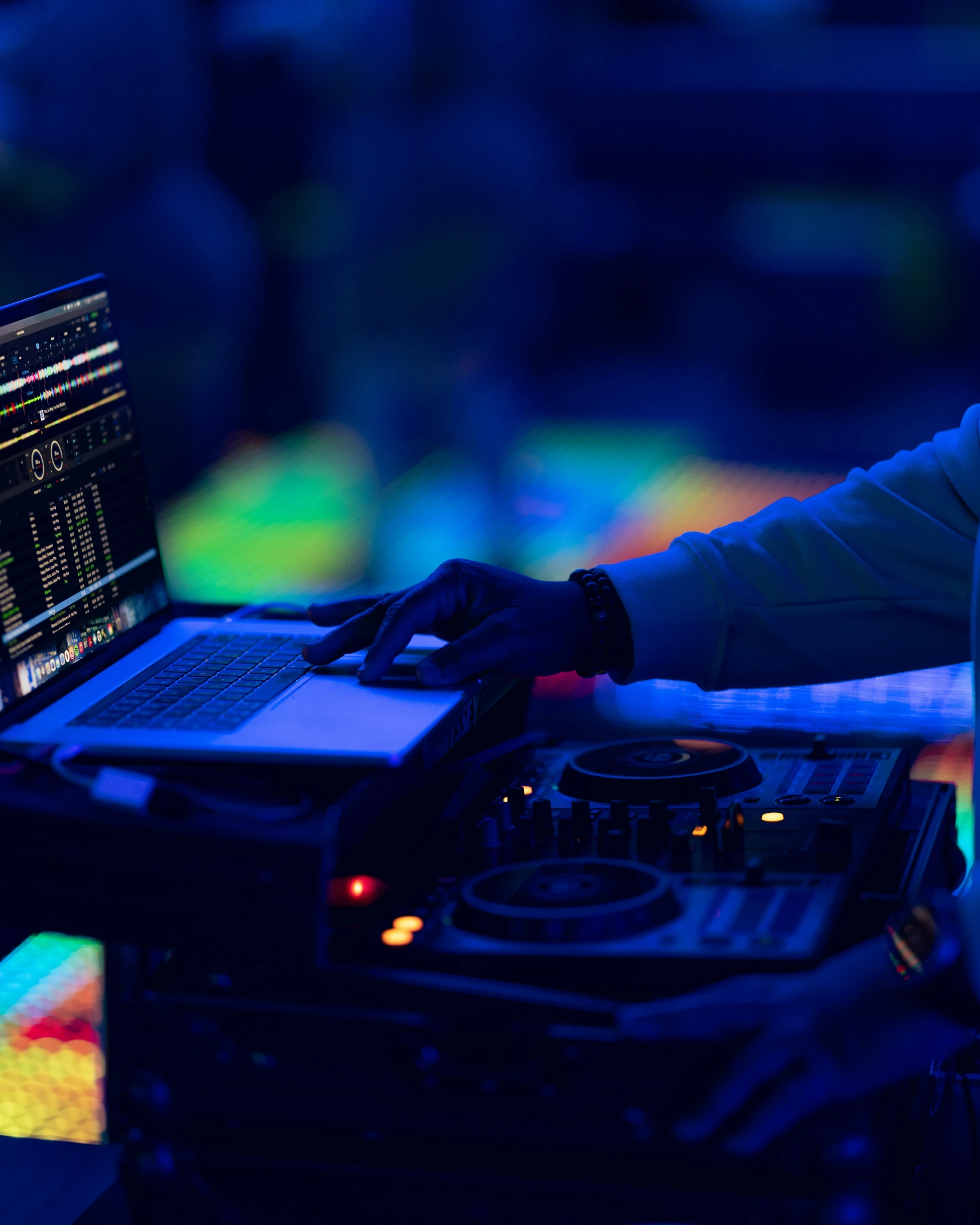 a laptop sitting on top of a sound mixing console