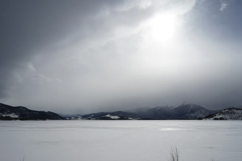 a snowy landscape is featured on a cloudy day