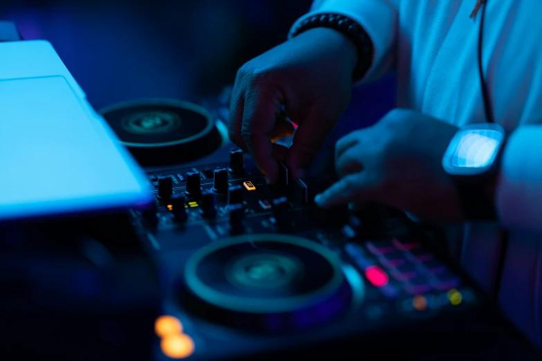 a dj uses the decks to record his tracks