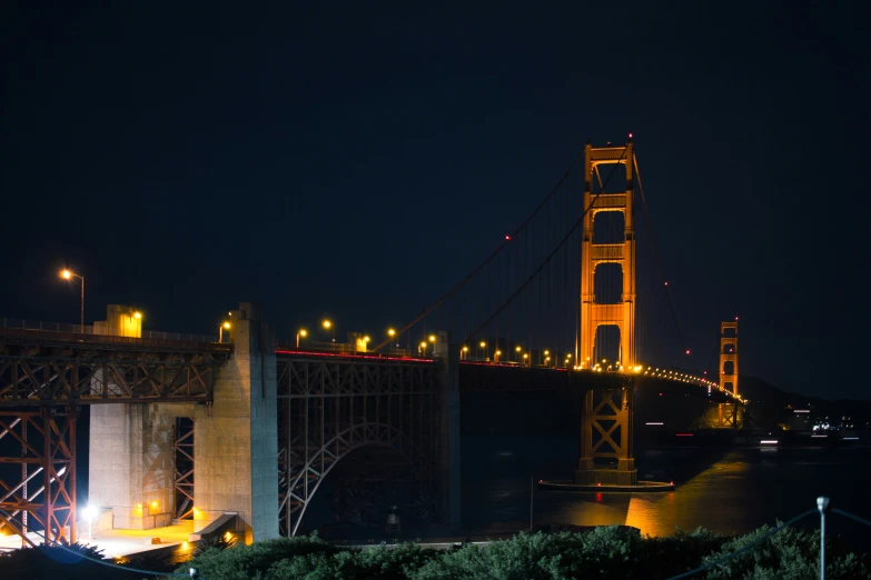 a night time picture of a large bridge with lights lit up