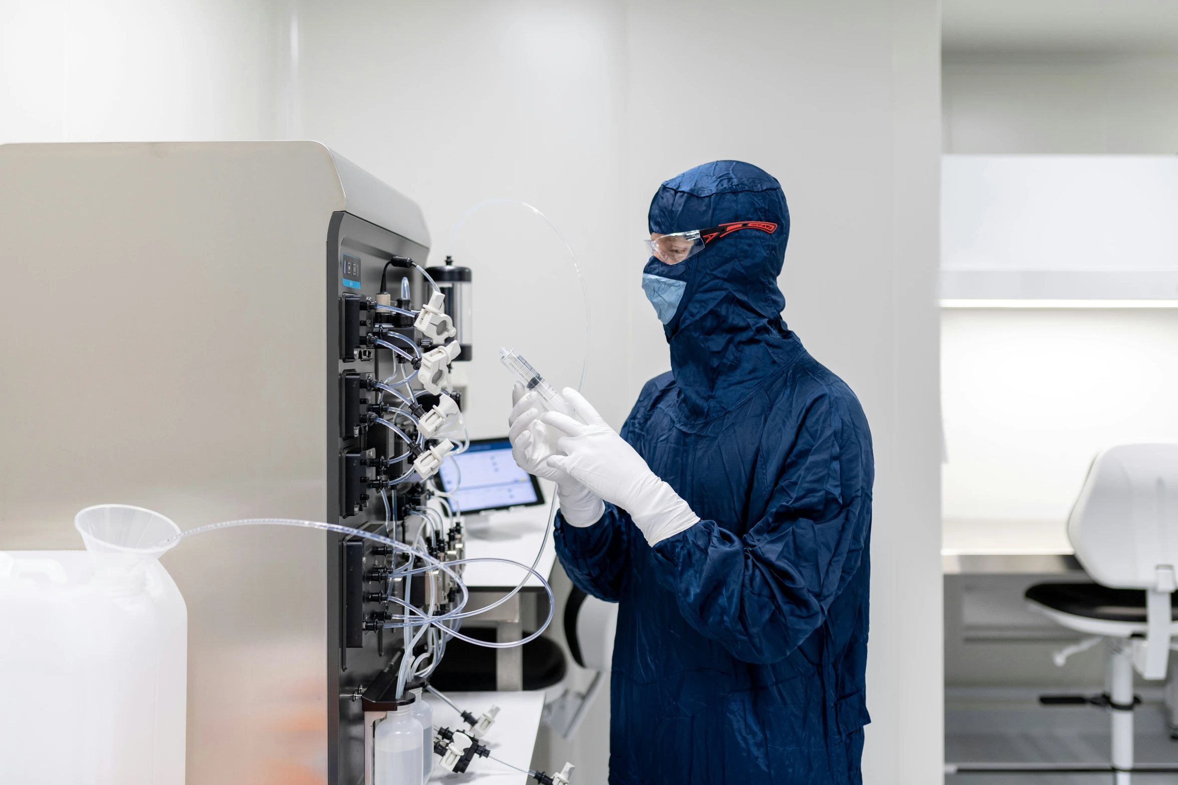 a man in blue jacket and mask looking at electrical equipment