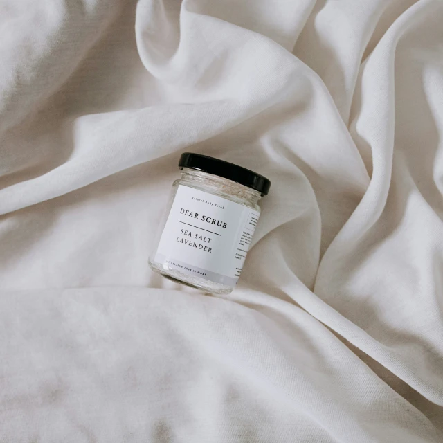 a jar of white flour sitting on top of a bed