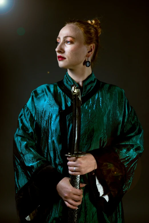 a woman in a green dress holding a glass