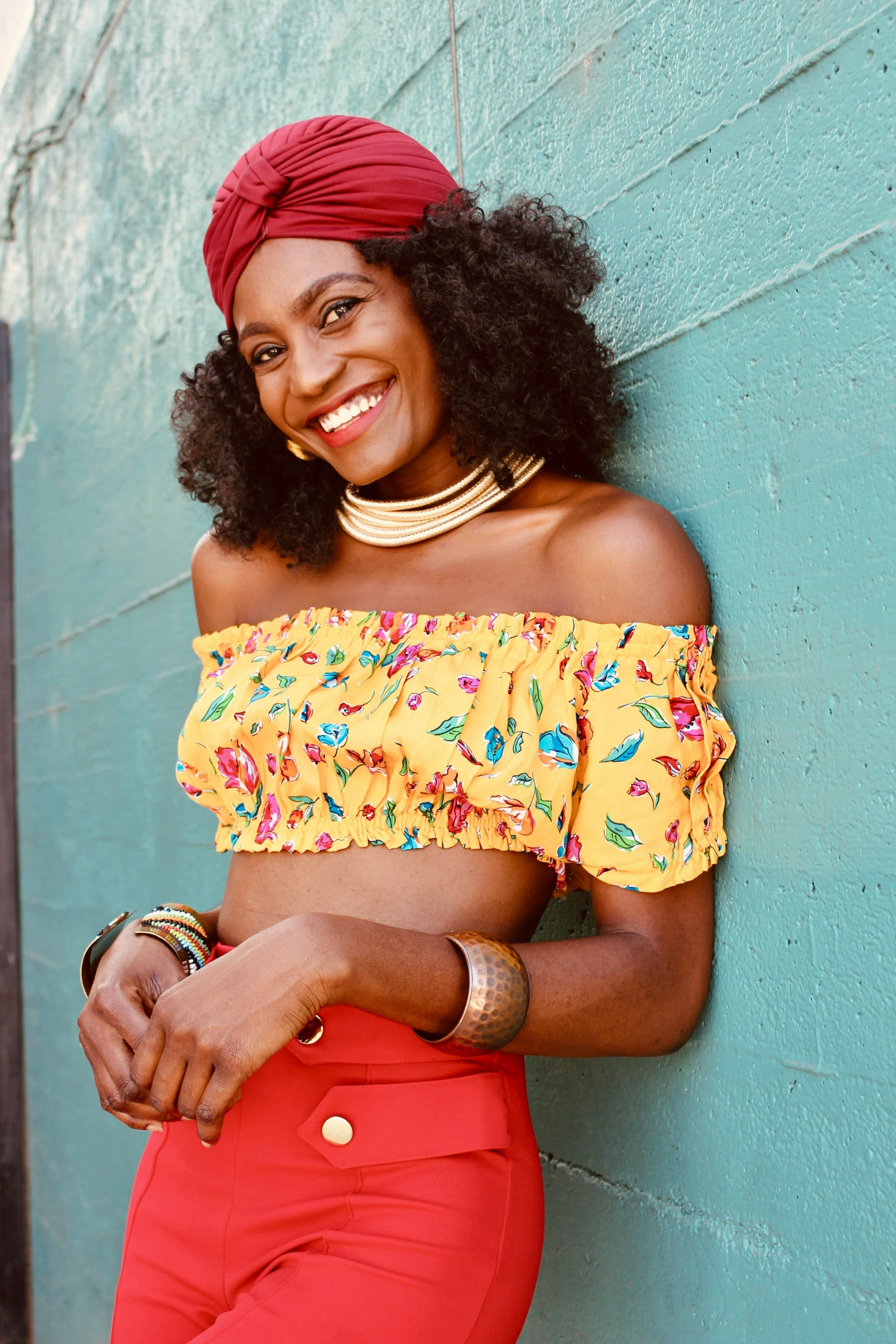 a woman standing against a blue wall posing for a picture