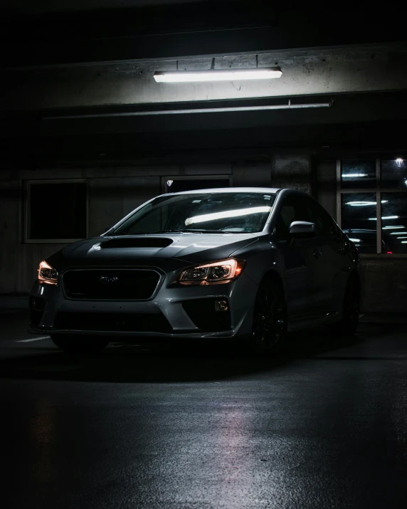 car parked in dark parking garage area at night