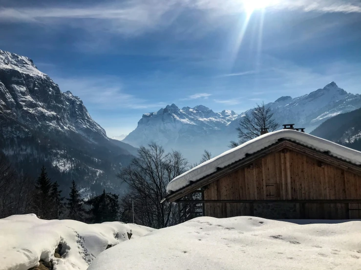 sun beams beaming down over a snowy mountain landscape