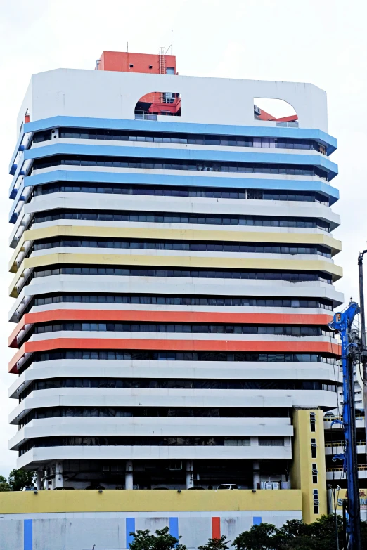 a building that is next to trees and cars