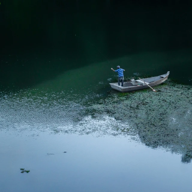 two people are in a small boat on the water