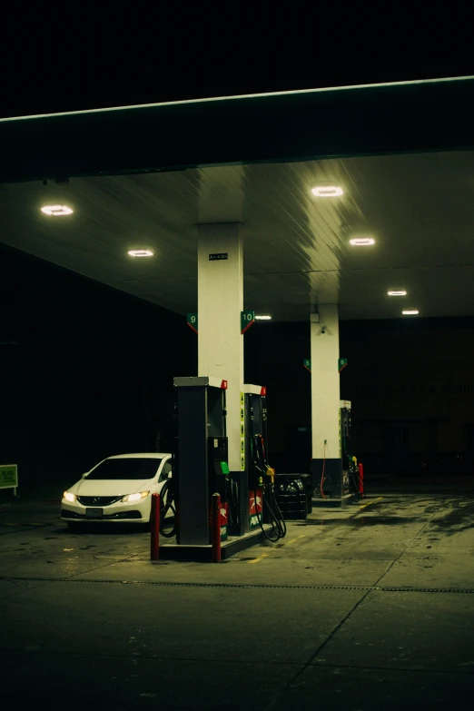 cars at a gas station are waiting for their filling